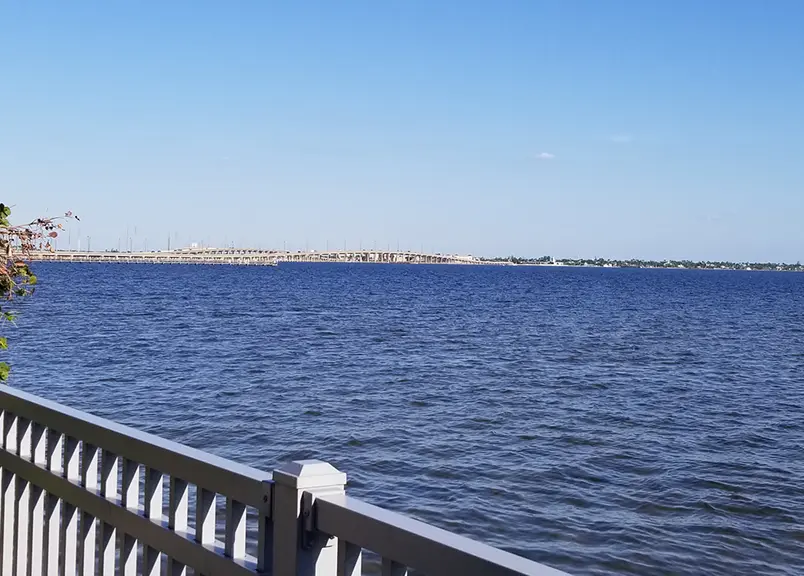 Scenic Port Charlotte coastal park with palm trees and harbor views, easily accessible from Arcadia, Florida accommodations near attractions.